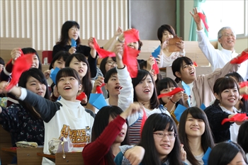 写真：紙からハンカチが出てくるマジックに挑戦する学生