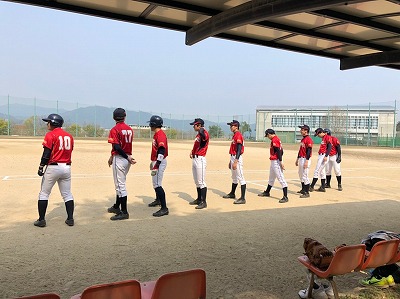 ベンチの前で整列する野球部員