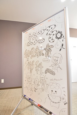 写真：幼児教育学科のブース前に手書きのウェルカムボードが立つ