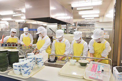 写真：洗浄担当の学生たちが使い終わった調理器具や食器を洗浄する