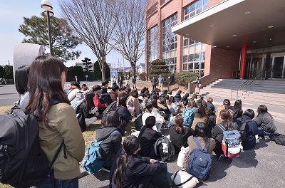 写真：激励をする教員。聞き入る学生