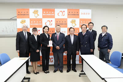 ライオンズクラブ中島氏から寄付金を受け取る学生