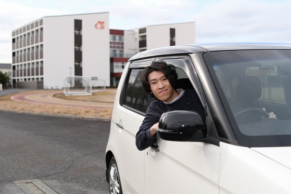 写真：車の窓から顔を出しているMさん